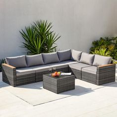 an outdoor couch and coffee table on a patio