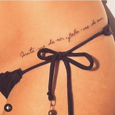 the back of a woman's stomach with an inscription on it that reads,