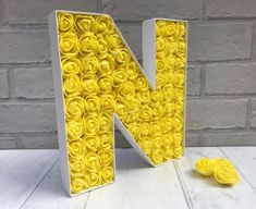 the letter n is made out of yellow roses