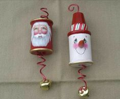 two christmas mugs are hanging on the wall