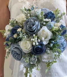 a bride holding a bouquet of blue and white flowers