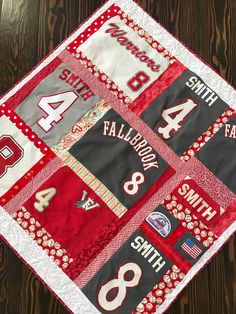 a quilted table runner with the number four on it and numbers in red, white and black