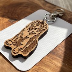 a wooden keychain with an image of a tiger on it