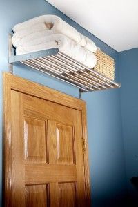 a wooden door with a towel rack above it