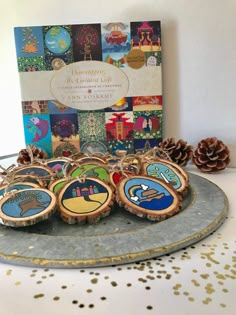 wooden ornaments are on a plate with pine cones and confetti in the background