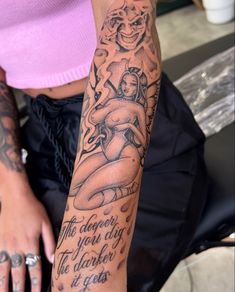 a woman with tattoos on her arm and hand