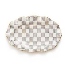 a checkered plate with gold trim on the edge and white, black and grey designs