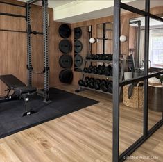 a home gym is shown in the middle of a room with wood floors and walls