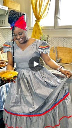 a woman standing in a kitchen preparing food