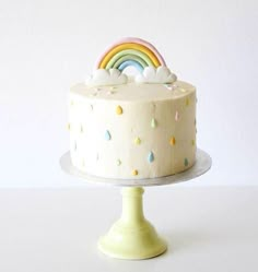 a cake with white frosting and rainbow decorations