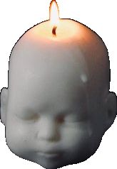 a small white candle with a face on it's side and a light in the middle