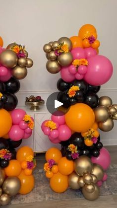 balloons are arranged in the shape of mickey mouse's ears with flowers on them