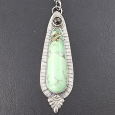 "A variscite stone is combined with a silver moonstone and set sterling silver to create this piece. The entire piece has been oxidized to bring out the detail. The pendant hangs from a sterling silver 24\" that is adjustable due to the nature of the chain. The pendant measures approx 2.75\" long. This piece is one of a kind and ready to ship. PAYMENT PLANS ARE AVAILABLE ON ALL ITEMS UPON REQUEST! CONTACT ME FOR MORE INFO To see more necklaces: http://www.etsy.com/shop/MicheleGradyDesigns?sectio Blue Stone Bracelet, Kyanite Earrings, Metalsmithing Jewelry, Precious Metal Clay, Silver Jewelry Design, Silver Work, Green Stone, Handmade Pendants, Necklace Silver