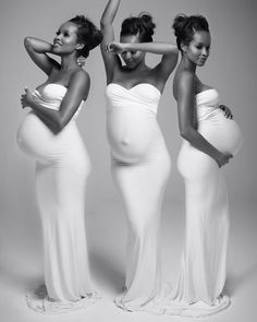 three pregnant women in white dresses posing for the camera with their hands on their hips