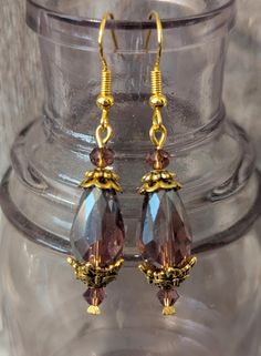 Opulent and fancy Edwardian style earrings!! Handcrafted using iridescent purple faceted crystal teardrop beads, purple Preciosa Crystal faceted bicone and round beads, antique gold tone brass milgrain detailed flower and quatrefoil bead caps and gold plated head pins and ear wires!! Length 2" Gift Faceted Beads Dangle Teardrop Earrings, Gift Dangle Teardrop Earrings With Faceted Beads, Gift Teardrop Dangle Earrings With Faceted Beads, Faceted Beads Teardrop Earrings Gift, Gift Teardrop Earrings With Faceted Beads, Purple Teardrop Beaded Earrings, Teardrop Earrings With Faceted Beads For Gifts, Purple Faceted Bead Dangle Crystal Earrings, Nickel-free Purple Teardrop Crystal Earrings