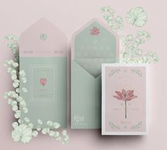 the wedding stationery is laid out on top of each other with flowers and leaves