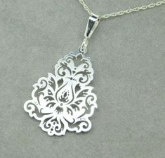 "All of our jewelry is guaranteed authentic by our Graduate Gemologist of the Gemological Institute of America (GIA). 935 Argentium Sterling Laser Cut Pendant Flower (#J4409) New custom-designed laser-cut argentium 935 sterling pendant with pierced chrysanthemum design. Argentium is a higher grade sterling that is a tarnish-resistant formula. Includes new 18\" sterling chain. Pendant measures 1 3/4\" long and weighs 3.1dwt. Note: See our other listing for the matching earrings SKU#J4404. Lovely! Chrysanthemum Design, Sterling Silver Flatware, Chrysanthemum Flower, Earrings Design, Silver Tea, Big Bend, Gold Wash, Design Jewelry, Chain Pendant