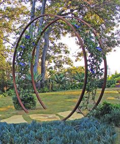 an artistic sculpture in the middle of a garden