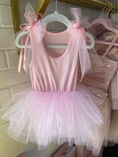 Super comfy one piece romper with handmade tulle bows and and satin ribbon bows hand sewn on the shoulders. Perfect for when you want something fancy but still easy peasy! Skirt is the same tiered layered style as our traditional tutu skirts and the top is ultra soft and comfortable to play in! Two snap button closure at crotch. Racerback style. Available in pink, black and white! Please indicate color at check out. This item should be spot cleaned or dry cleaned only. Please allow 1 week to shi Fitted Sleeveless Tutu Dress With Bow, Pink Fairy Tutu Dress For Summer, Summer Ballet Tutu Dress For Dress-up, Pink Fairy Style Tutu Dress For Summer, Princess Tutu Dress With Satin Bow, Princess Style Tulle Tutu Dress With Satin Bow, Sleeveless Tulle Tutu Dress With Bow, Pink Summer Tutu Dress For Costume Party, Pink Tutu Dress For Summer Costume Party