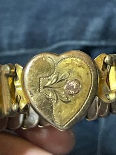 This antique sweetheart expansion bracelet is a great way to show that special someone that you care.  It has Patricia Made in USA on the inside of the wristband. It has a  lovely flower engraved on the front of the heart, accented by a rose gold flower. Vintage Gold Heart Bracelet For Anniversary, Vintage Gold Bracelets For Valentine's Day, Antique Heart-shaped Bracelets For Gift, Antique Heart-shaped Bracelets As Gift, Antique Heart-shaped Bracelet For Gift, Vintage Adjustable Heart Bracelets, Vintage Heart Bracelet For Valentine's Day Anniversary, Vintage Heart-shaped Bracelet With Charm, Vintage Heart-shaped Bracelets With Charm