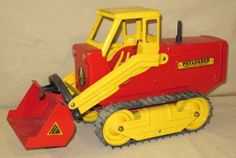 a red and yellow toy bulldozer sitting on top of a white surface