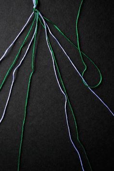 some green and white string on a black surface