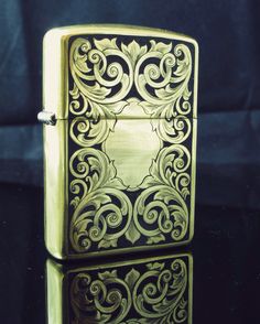 a gold colored lighter sitting on top of a table