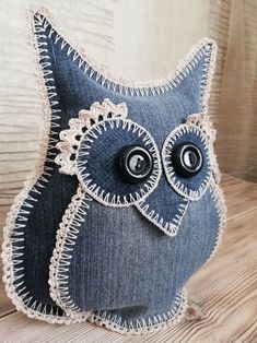 an owl made out of jeans on a wooden table