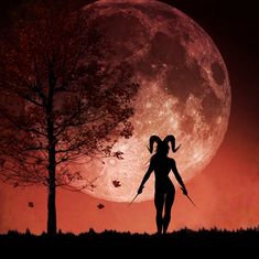 the silhouette of a woman holding two swords in front of a full moon