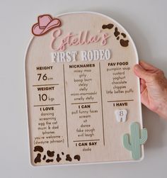 a wooden baby's first rodeo sign is shown with the date and time on it