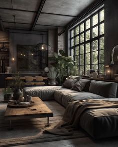 a living room filled with lots of furniture and large windows in the wall behind it