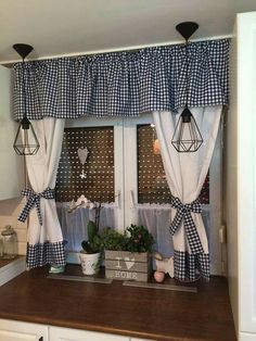 the kitchen window is decorated with black and white gingham curtains