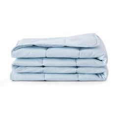 a stack of light blue sheets folded on top of each other in front of a white background