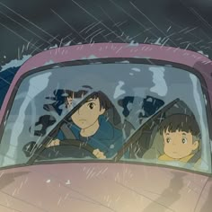 two people in a car driving through the rain