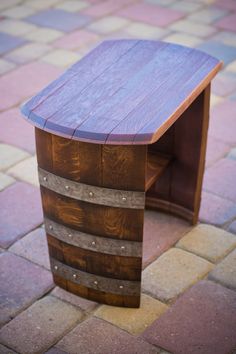 a wooden table sitting on top of a brick floor