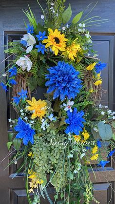 a wreath with blue, yellow and white flowers