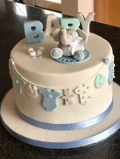 a baby shower cake with blue and white decorations