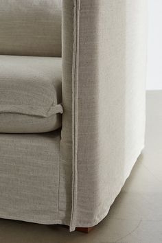 a close up view of the back end of a couch that is made out of linen