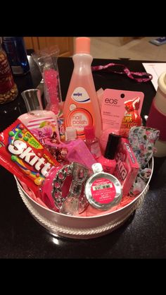 a basket filled with lots of different types of items on top of a black table