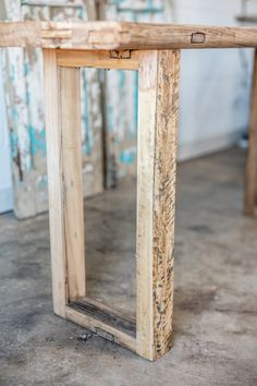 a wooden table sitting on top of a cement floor