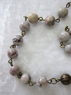 "This 5 decade beige rosary will make an ideal religious gift for a Catholic or Lutheran man or woman, It is made with 8mm maifanite rounds (Chinese medicine stone,) and brass metals. The links were hand turned by me. The chain is 30 inches around and has a 5\" drop for the cross. This rosary will be slipped into an organza bag and shipped in a bubble mailer." Handmade Brown Rosary For Healing, Vintage Adjustable Rosary With Round Beads, Vintage Adjustable Rosary, Brown Healing Rosary With Round Beads, Healing Brown Rosary With Round Beads, Seafoam Color, First Communion Gifts, Rosary Necklace, Communion Gifts