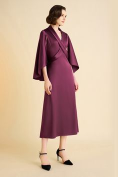 Elevate your style with our enchanting cape dress, designed to make a statement at any occasion. The sophisticated cross neckline creates a visually striking effect, while the cascading cape detail adds an element of drama and elegance, perfect for a grand entrance. The A-line dress gracefully flares out, offering a flattering silhouette that moves effortlessly with every step, exuding timeless charm and refinement. Features: Elegant cape detail Cross neckline A-line silhouette High-quality fabr Pre-draped Cape Evening Dress, Chic Cape Dress For Formal Occasions, Satin Evening Dress With Cape Sleeves, Elegant Evening Maxi Dress With Kimono Sleeves, Elegant Fitted Dress With Kimono Sleeves, Evening Cape Maxi Dress With Draped Sleeves, Evening Maxi Dress With Draped Sleeves And Cape Shape, Elegant Party Cape With Cape Sleeves, Elegant Evening Capelet