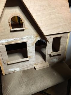 a doll house made out of plywood and wood