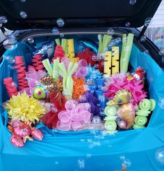 an open trunk filled with lots of different colored hair clips and bows on top of it