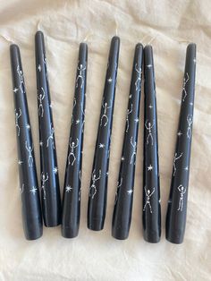 Black taper dinner candles are hand painted with Halloween inspired white dancing skeletons. Upcycled Candles, Painted Skeleton, Pretty Candles, Spooky Dinner, Halloween Box, Gothic Candles