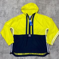 Yellow And Navy Blue Adidas Sporty Windbreaker, Adidas Blue Sporty Windbreaker, Sporty Blue Adidas Windbreaker, Adidas Windbreaker With Pockets For Spring, Adidas Spring Windbreaker With Pockets, Spring Navy Windbreaker For Streetwear, Navy Windbreaker For Spring Streetwear, Navy Spring Windbreaker For Streetwear, Blue Adidas Windbreaker For Sports