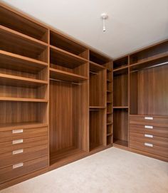 an empty room with wooden shelves and drawers on the bottom shelf, one person tried it galan't