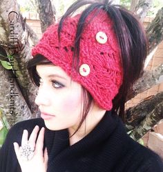 a woman wearing a red knitted headband with buttons