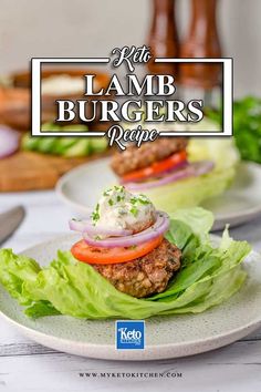 a burger with lettuce and tomatoes on it sitting on top of a white plate