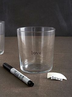 two shot glasses, one with the word love on it